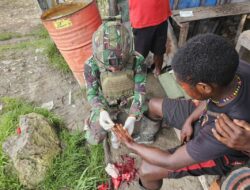 Satgas Yonif 323 Kostrad Memberikan Pertolongan Pertama Masyarakat Yang terluka